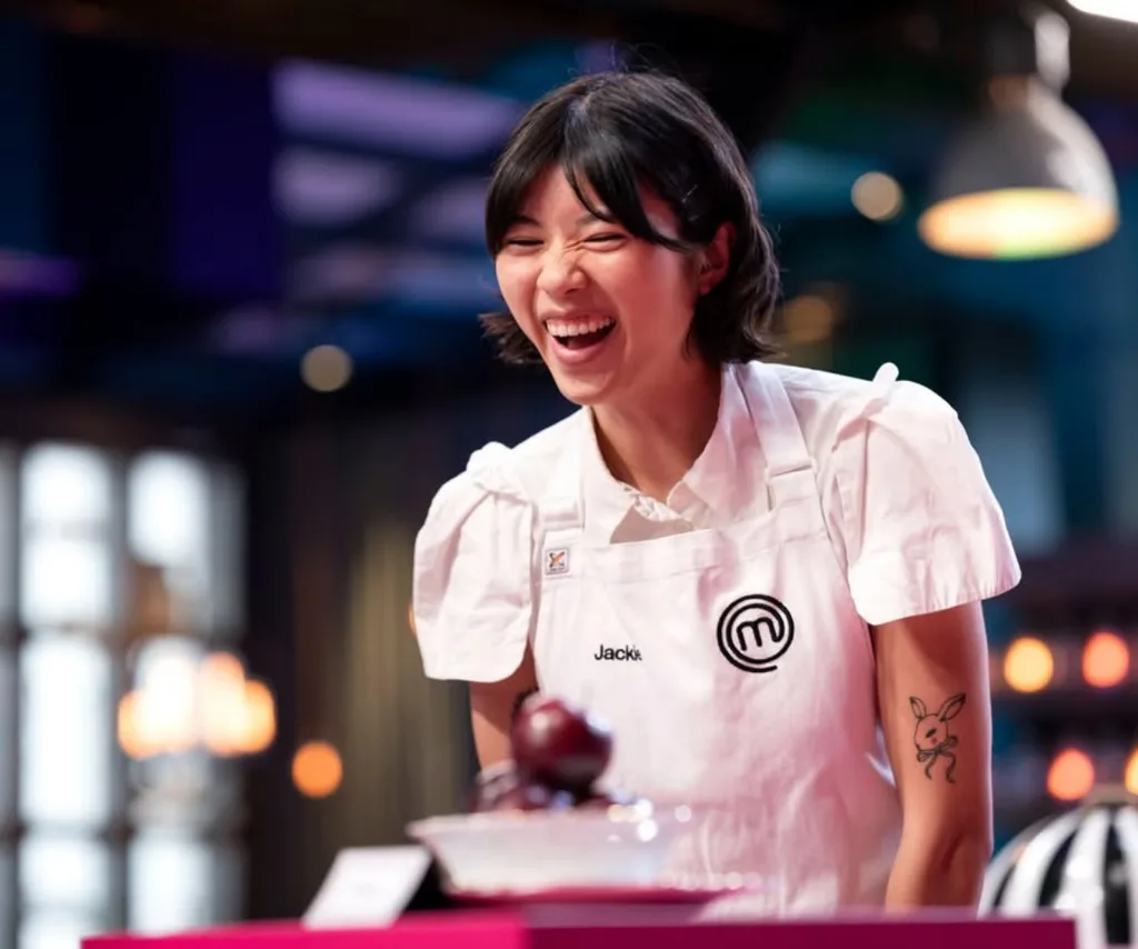 Jackie from MasterChef Australia smiling in the kitchen.