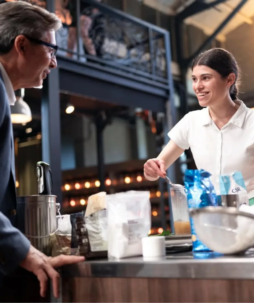 Bella Di Conzo in the MasterChef Australia redemption cook behind her bench talking to judge Jean-Christophe.