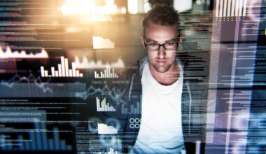 A man sits in casual clothes in front of a computer amid graphic images of data superimposed on the image, as though he is engaged in IT or hacking activities.