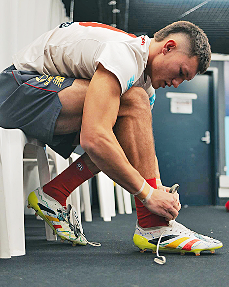 Gold Coast Suns midfielder Lachie Gulbin kicked a goal while wearing a pair of boots designed by Bamaga students.