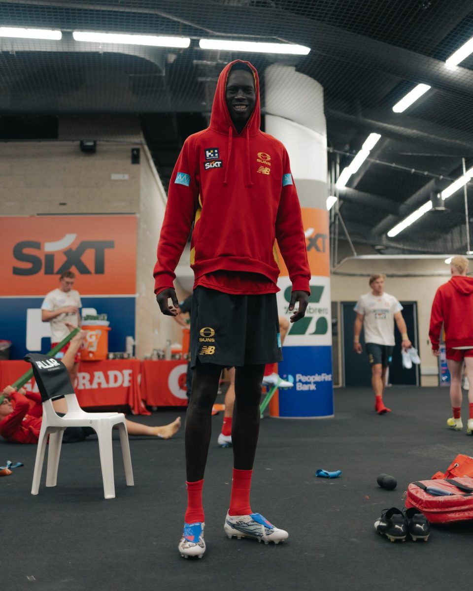 Suns defender Mac Andrew in boots designed by Bamaga students.