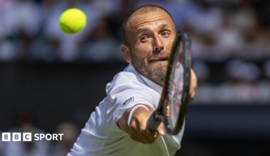 Dan Evans stretches to hit a backhand volley