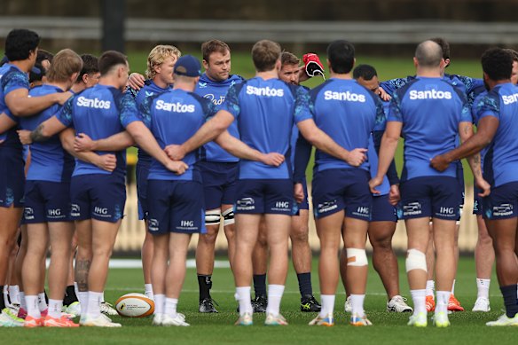 Wallabies talk in a huddle during a training session at North Sydney Oval.