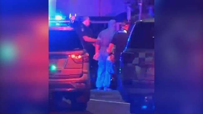 Ethan Midgley was spotted being led away in a blue forensic suit.