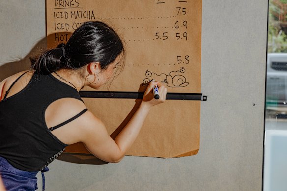 Tam incorporates her signature hand-drawn snail logo into menus and packaging. 