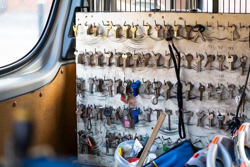 a board of keys and tools hanging in a locksmith van