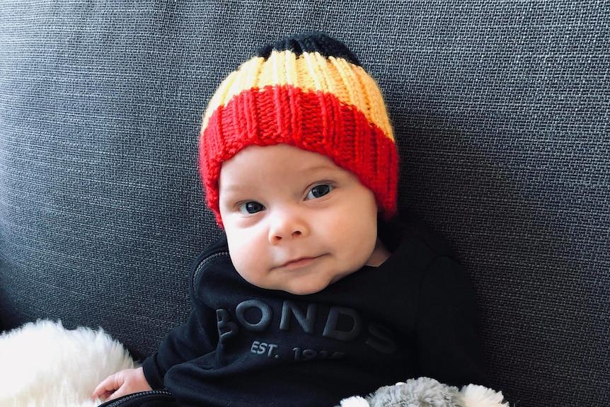 A cute baby with a beany on