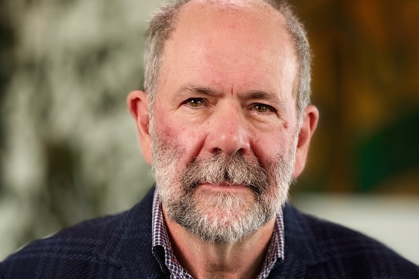 Close-up of a man with a short, grey beard
