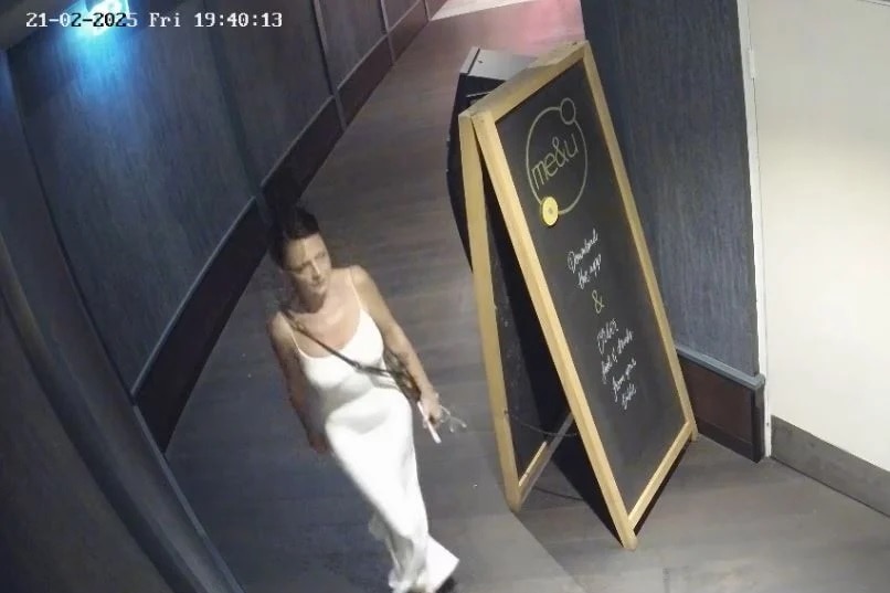 The woman was last seen wearing a long slim-fitting white dress with a brown leather satchel.