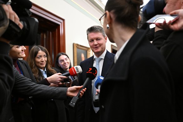 Ben Carroll takes questions after emerging from a caucus meeting.
