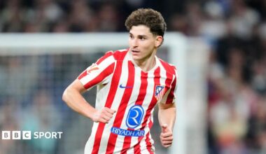 Julian Alvarez running in Atletico Madrid's red and white striped home shirt