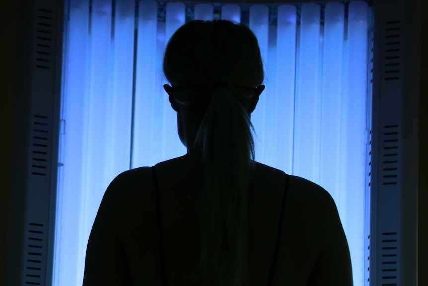 A woman uses a solarium.
