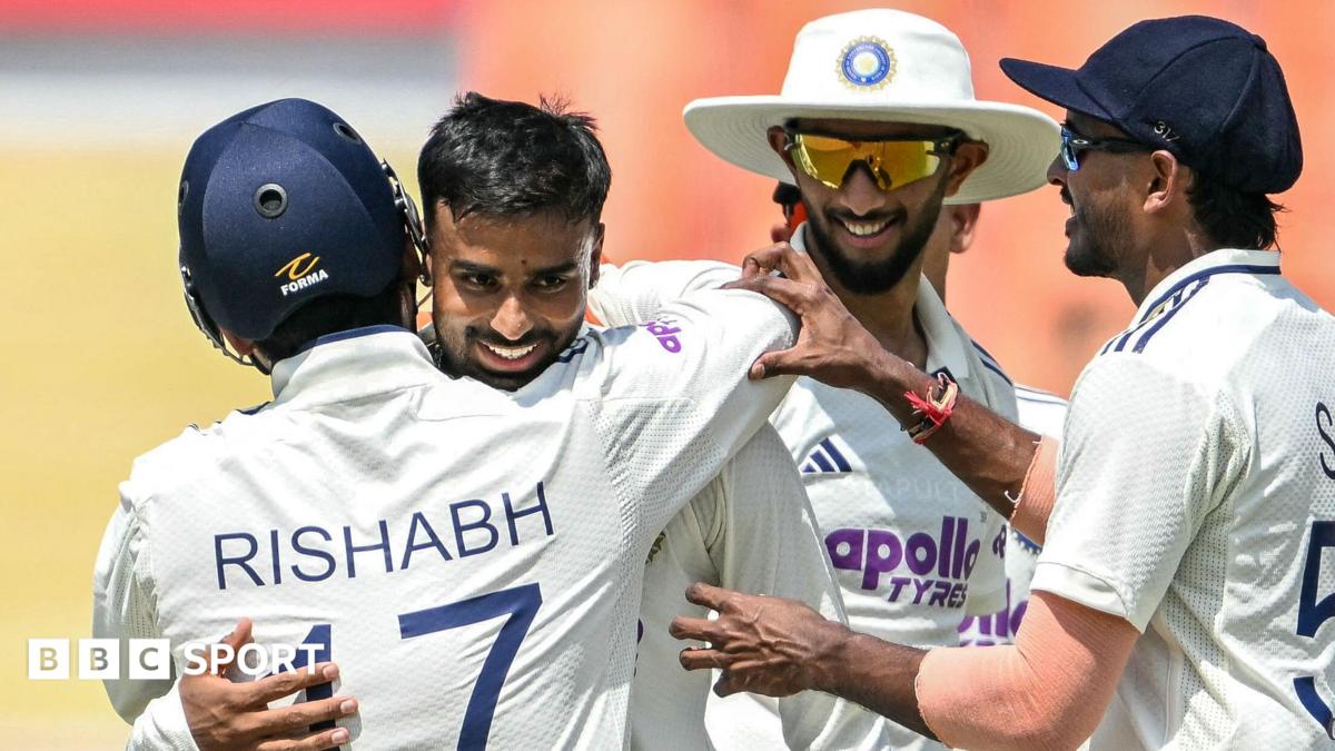 India's Manav Suthar is congratulated by team-mates