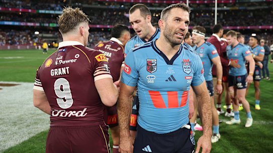 A dejected James Tedesco and Blues leave the field after their heavy loss in Melbourne.