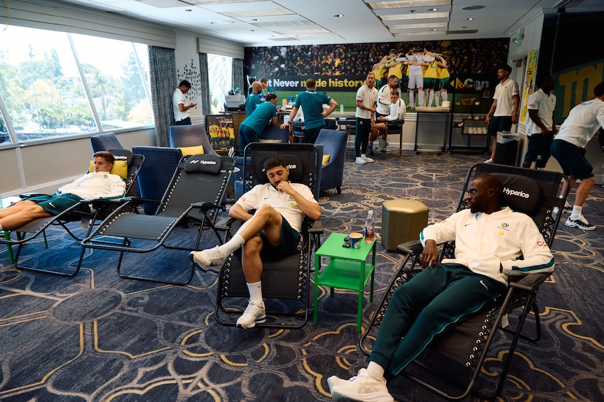 Socceroos players relax in the recreation room at the Claremont Country Club