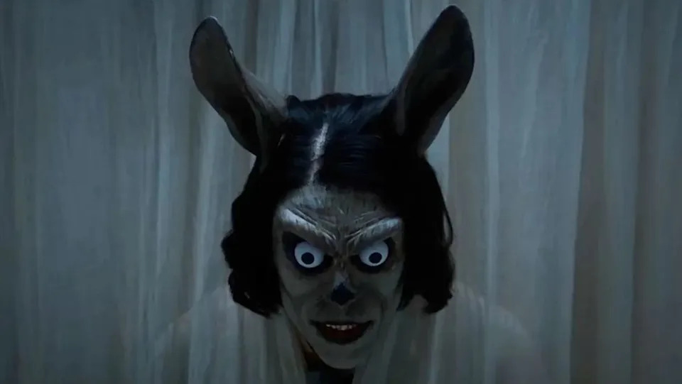 A horrifying face in the teaser for Hokum.