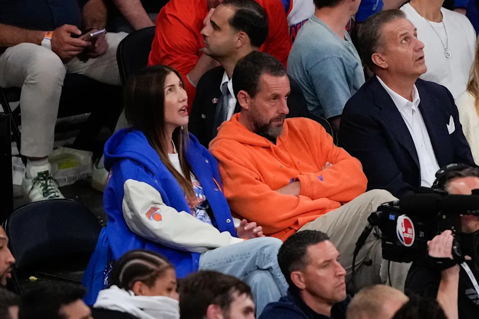 Jackie and Adam Sandler watch during the first half of Game 4.