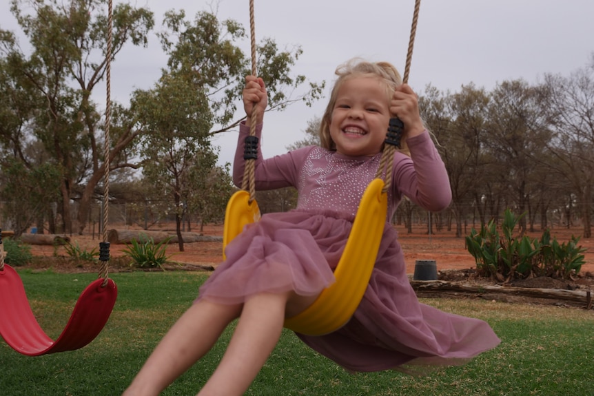 young girl on a swing