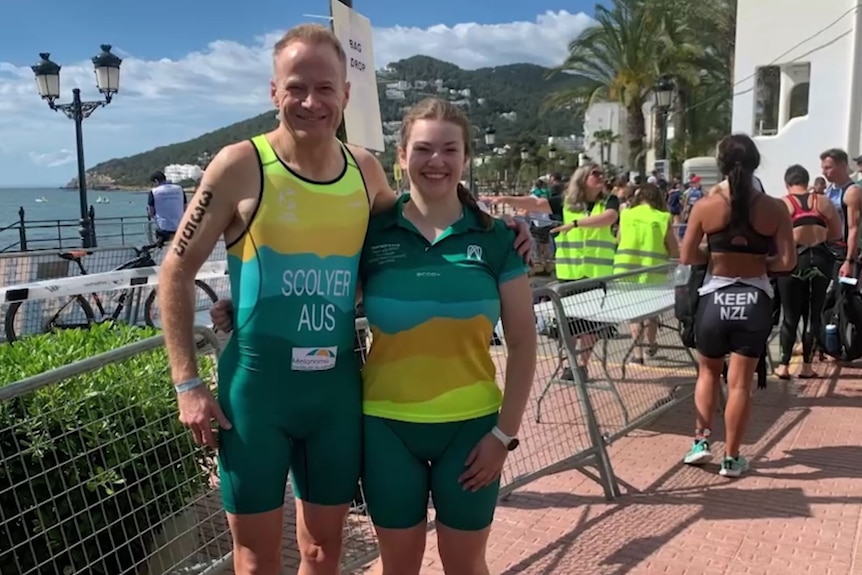 Richard Scolyer stand together, smiling, both wearing athletic great in green and gold colours