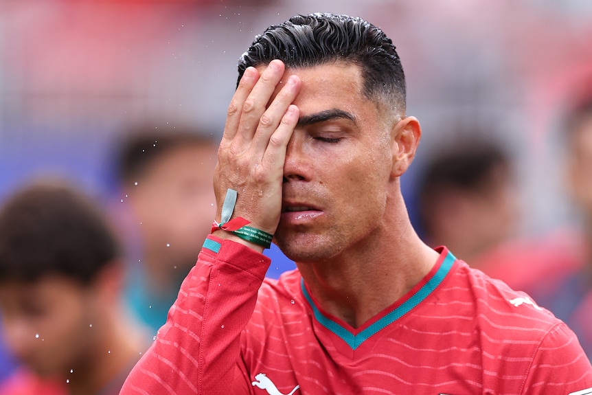 Ronaldo holds his hand to his face