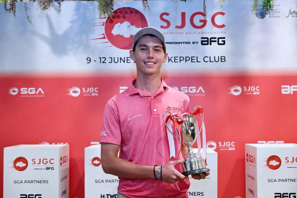 Singapore's Troy Storm holds the Singapore Junior Golf Championship A Boys strokeplay trophy after delivering an eight-stroke victory with a 17-under score of 199.