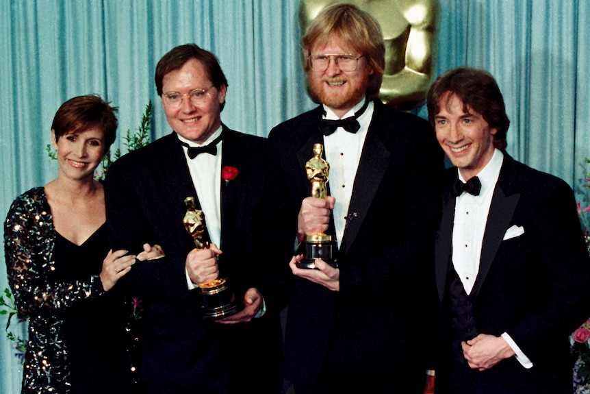 John Lasseter (second from left) with his Oscar for Tin Toy at the 1989 Academy Awards.