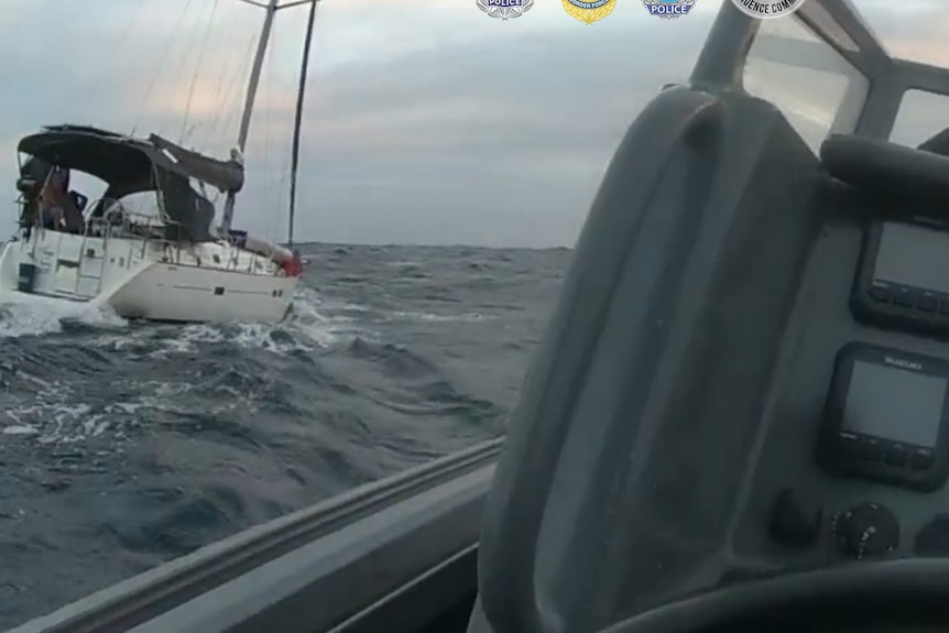A white yacht to left of screen on the ocean