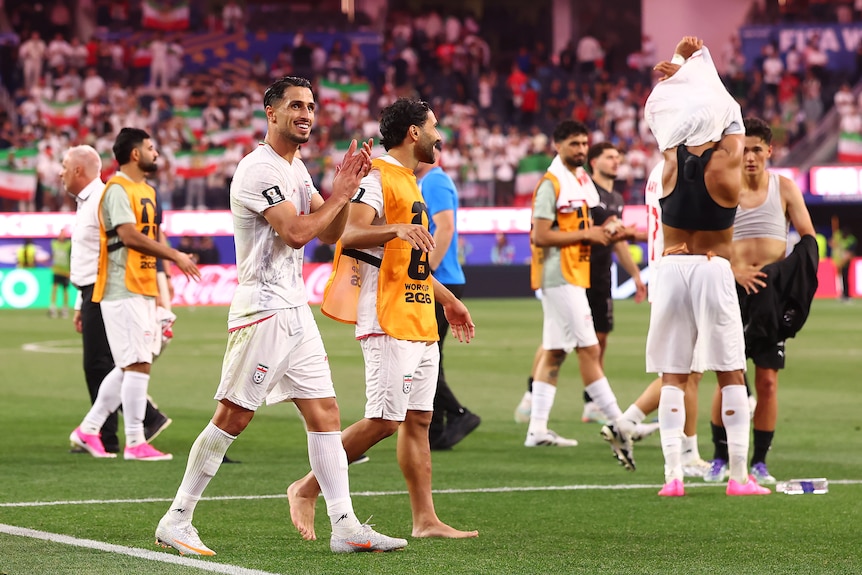 Iranian players applaud fans