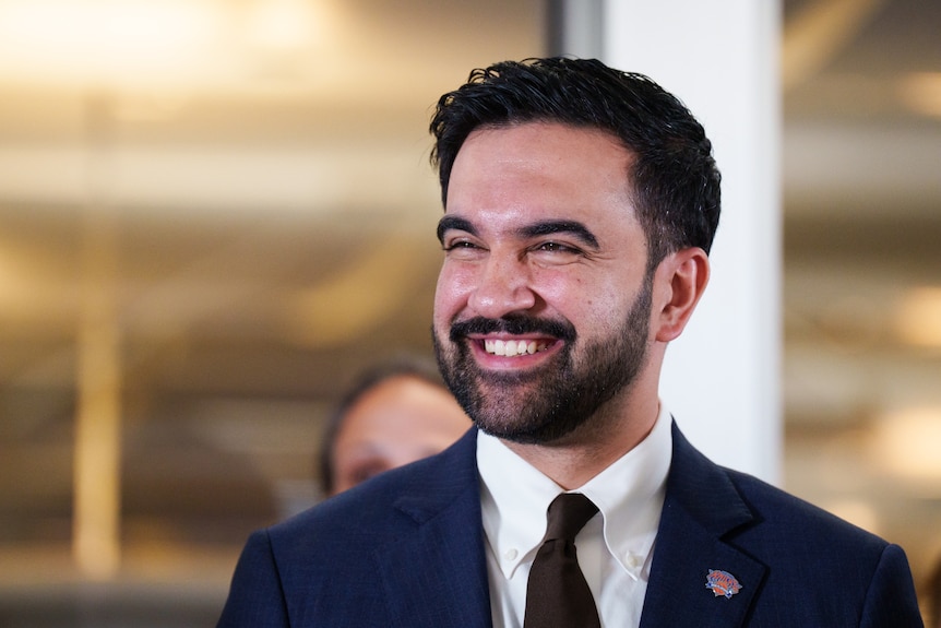 Zohran Mamdani smiles.