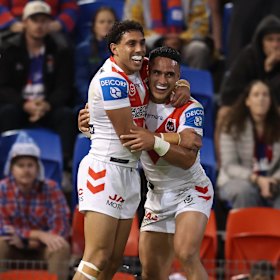 Tyrell Sloan and Val Holmes celebrate a Dragons try.