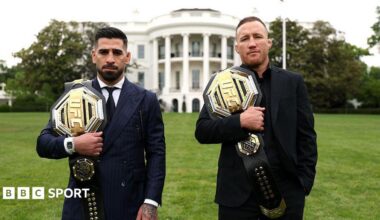 Illia Topuria (left) holds the UFC lightweight belt over his right shoulder and Justin Gaethje (right) has the UFC interim lightweight belt over his right shoulder