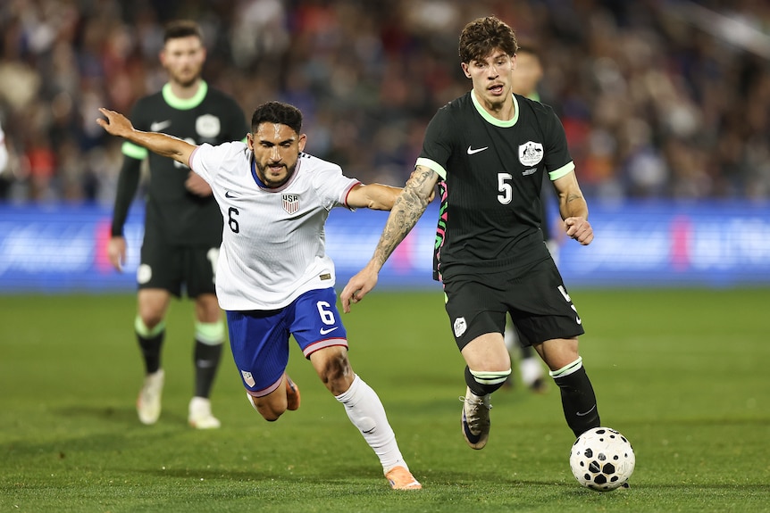 Jordan Bos of Australia competes with Cristian Roldan of the United States