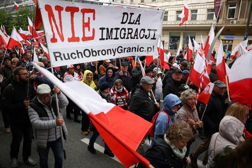 Protesters hold banners as they take part in a march against immigration in Poland.