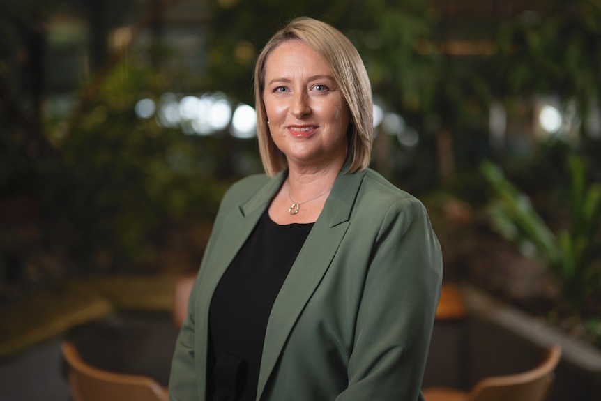Professor Amanda Kennedy stands in a green jacket.