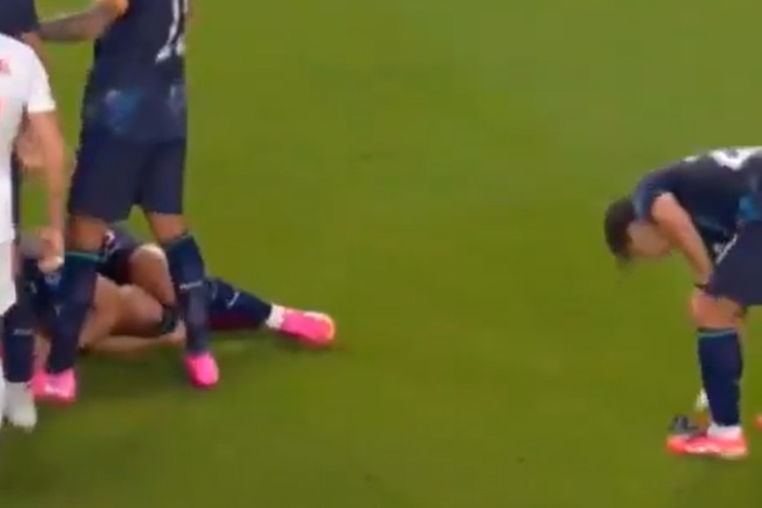 Paraguay's Matias Galarza picks up the referee's watch during a game.