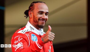 Lewis Hamilton gives a thumbs-up on the Monaco podium