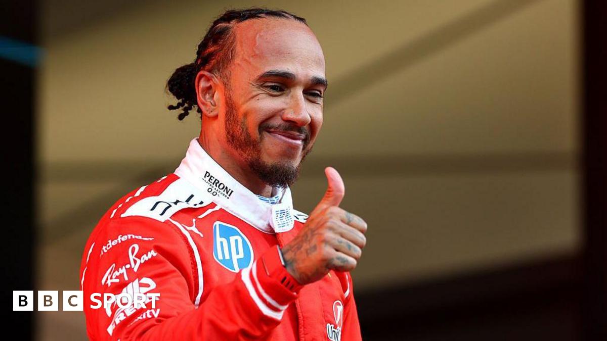 Lewis Hamilton gives a thumbs-up on the Monaco podium