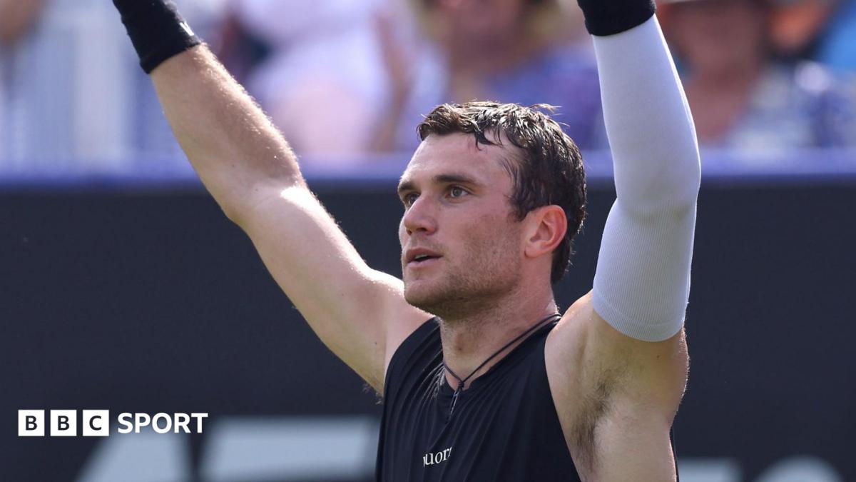 Jack Draper lifts his arms in celebration after winning his quarter-final at Eastbourne