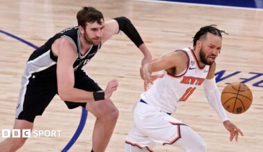 The San Antonio Spurs' Luke Kornet chases the New York Knicks' Jalen Brunson