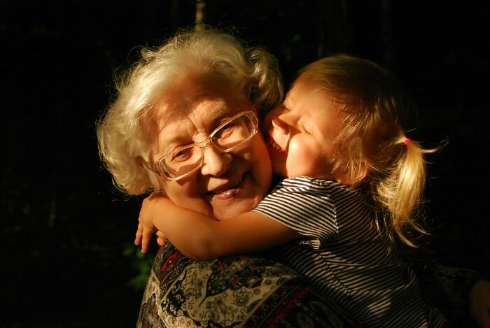 Older woman hugging child with dementia care expert insights