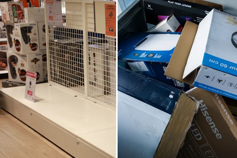 Bare shelves where fans were being sold next to a bin of used cardboard boxes