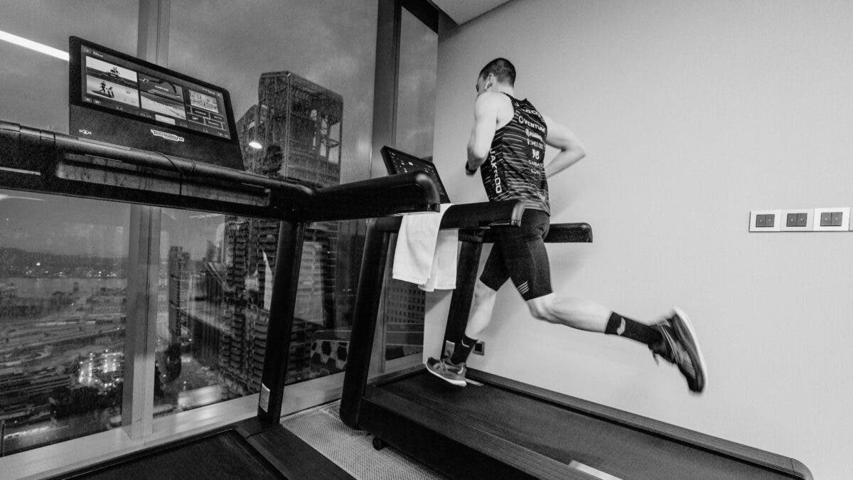 A man running hard on a treadmill.