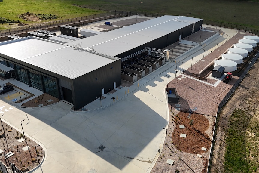 image of black building with water tanks and infrastructure