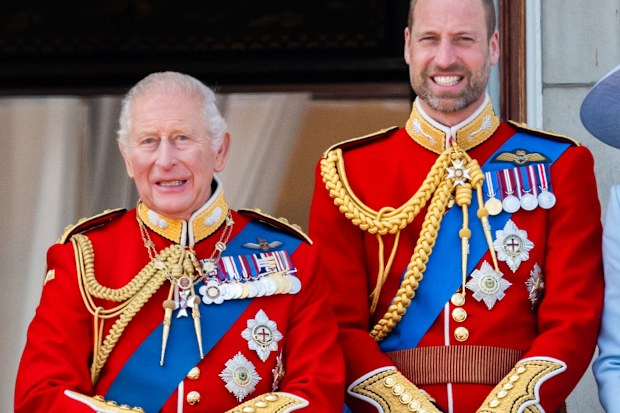 King Charles III and Prince William, Prince of Wales watch an RAF flypast from the balcony of Buckingham Palace during Trooping The Colour on June 13, 2026
