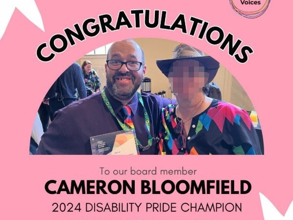 A pink poster that reads: "Congratulations Cameron Bloomfield 2024 Disability Pride Champion" with a photo of Cameron and person