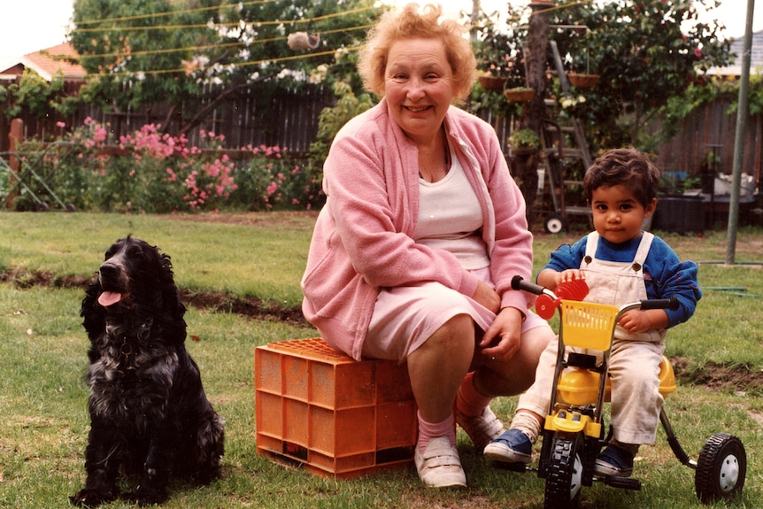 Marc, right, as a toddler on a tricycle with Mary Catherine, left, sitting on a tub and a cocker spaniel, far left.