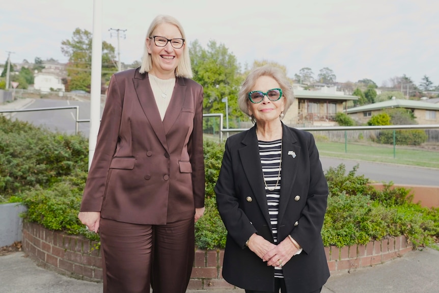 Two women pose for a photo.