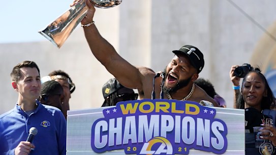 Shirt off, trophy up ... Aaron Donald holds the Vince Lombardi Trophy after the Super Bowl in 2022.