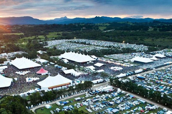 A drone shot of tents, cars and stages on a site