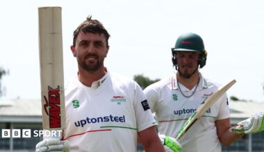 Leicestershire's Lewis Hill hold his bat up as he leaves the field